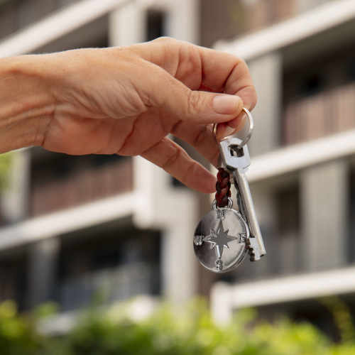 hand-holding-key-outdoors-min hand-holding-key-outdoors-min